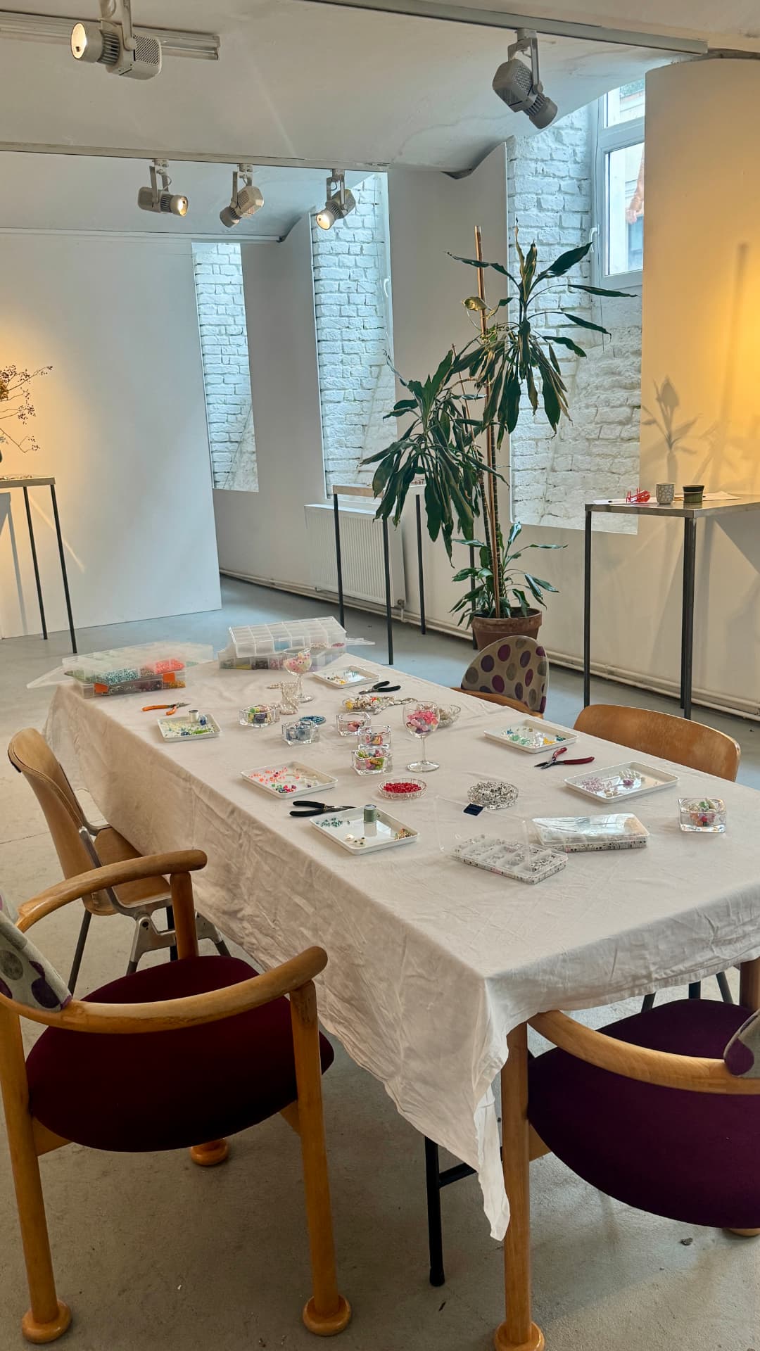 The workshop table set with beads and findings in the bright studio